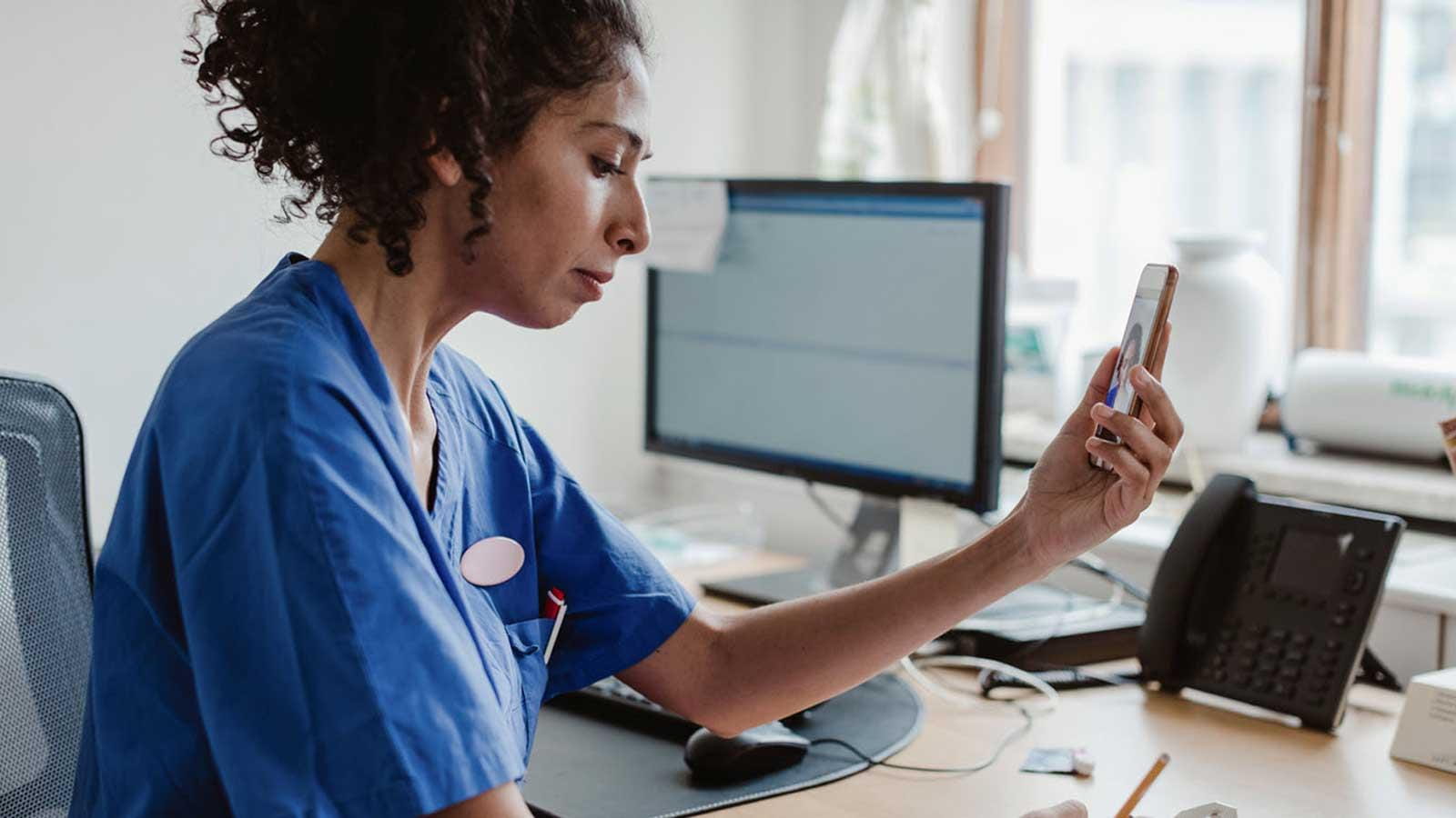 Nurse talking to patient through video chat