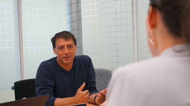 Pathogen Expert Nathan Roth in a meeting with staff