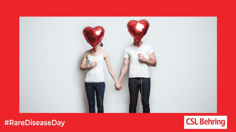 Couple holding heart balloons