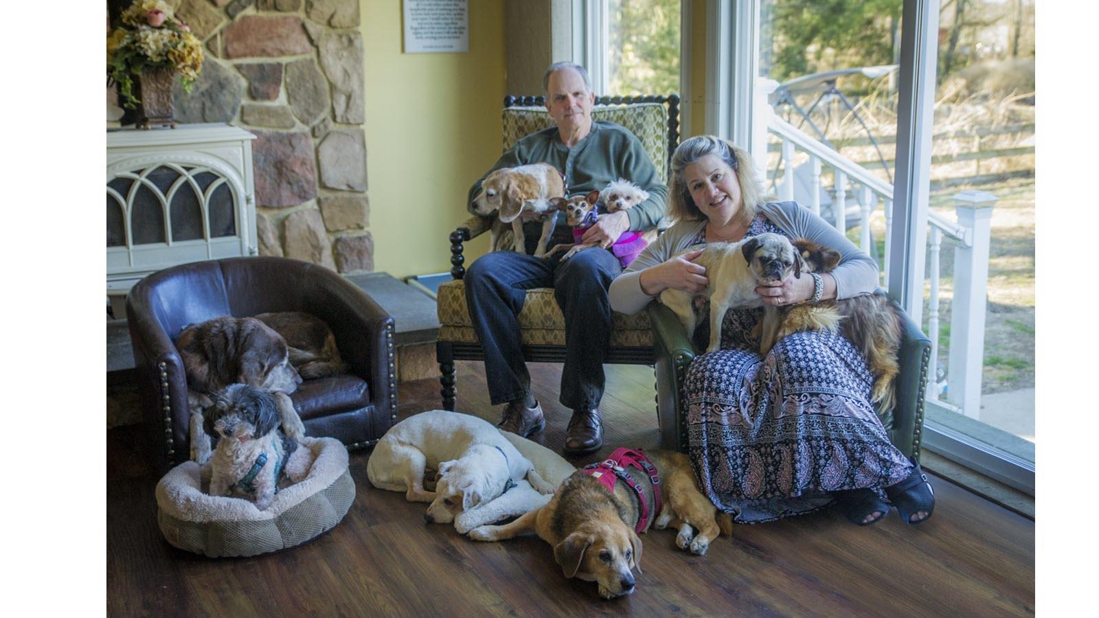 Jeff Allen and wife Michele surrounded by dogs they care for
