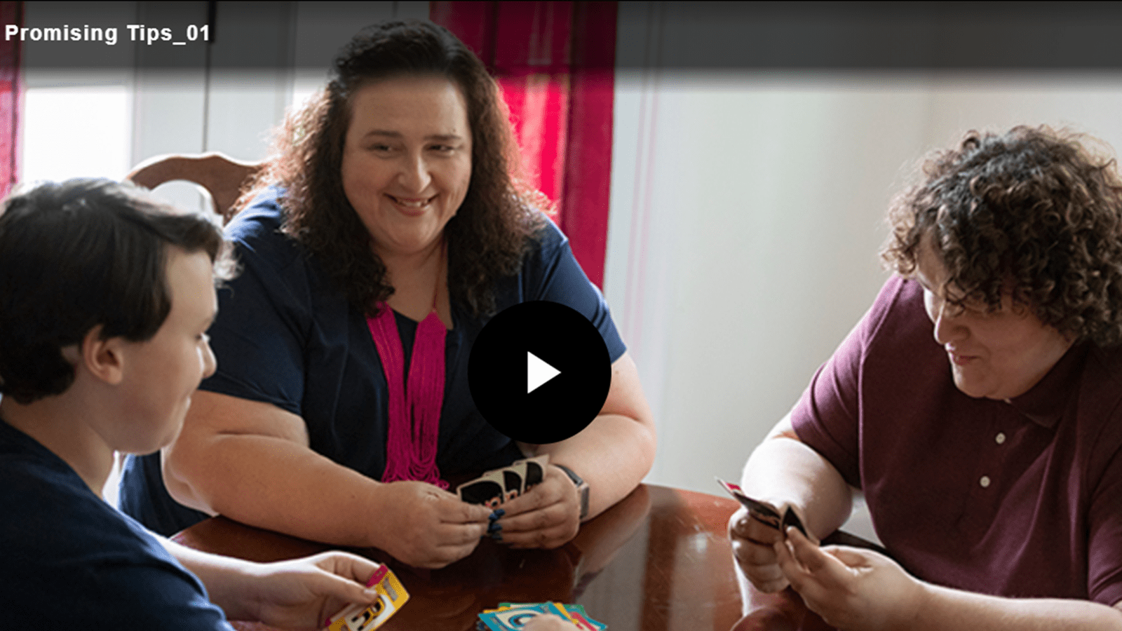 Machelle and her teen sons play a card game