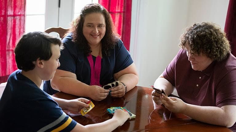 Hereditary angioedema patient Machelle Pecoraro playing cards with her children.