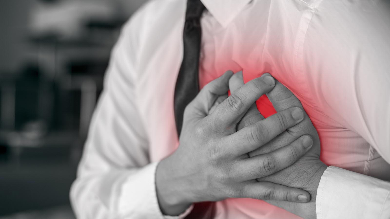 man clutching chest to illustrate a heart attack