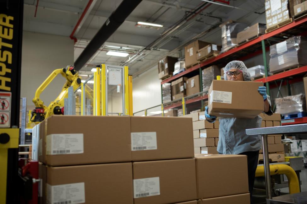 Workers package products at CSL Behring Kankakee, Illinois, manufacturing site