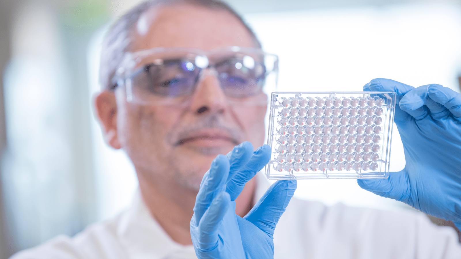 man holding a piece of medical equipment up in the light