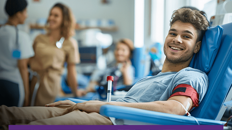 Photo of man sitting smiling while sitting in a donor chair at a CSL Plasma Center