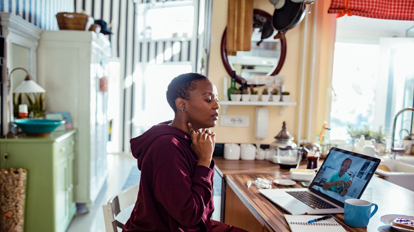 Woman engages in flu screening via a telehealth visit.
