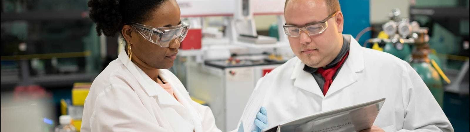 Technicians looking at binder