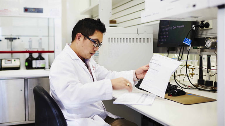 Scientist looking at reports