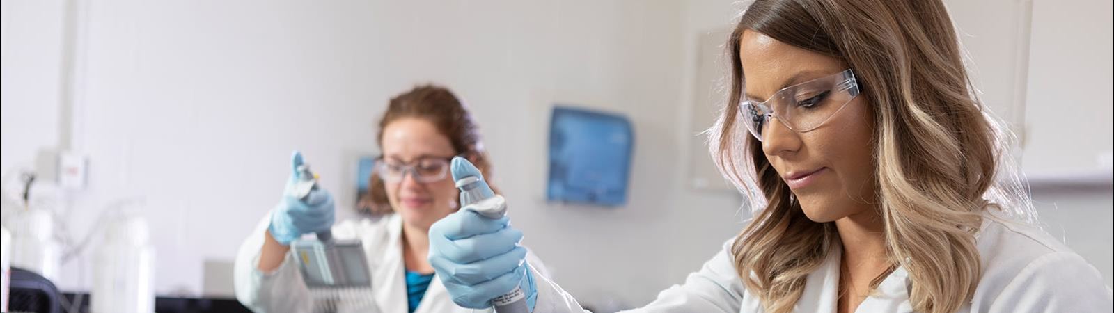 Two Female Researchers Testing Plasma in a Lab