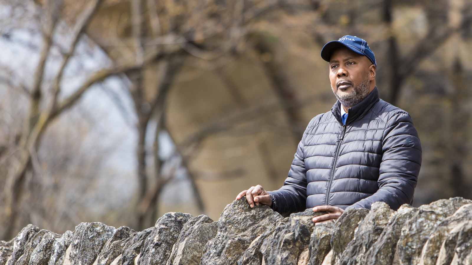 CIDP Patient Arthur standing near a rock wall