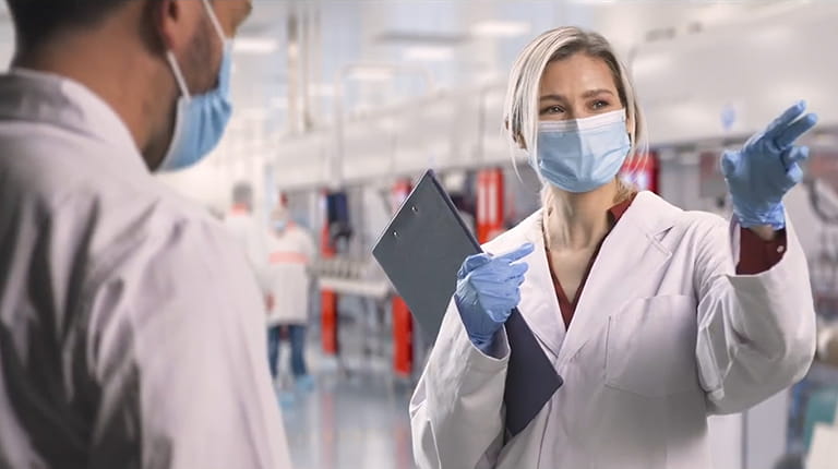Scientist sitting at desk reading papers