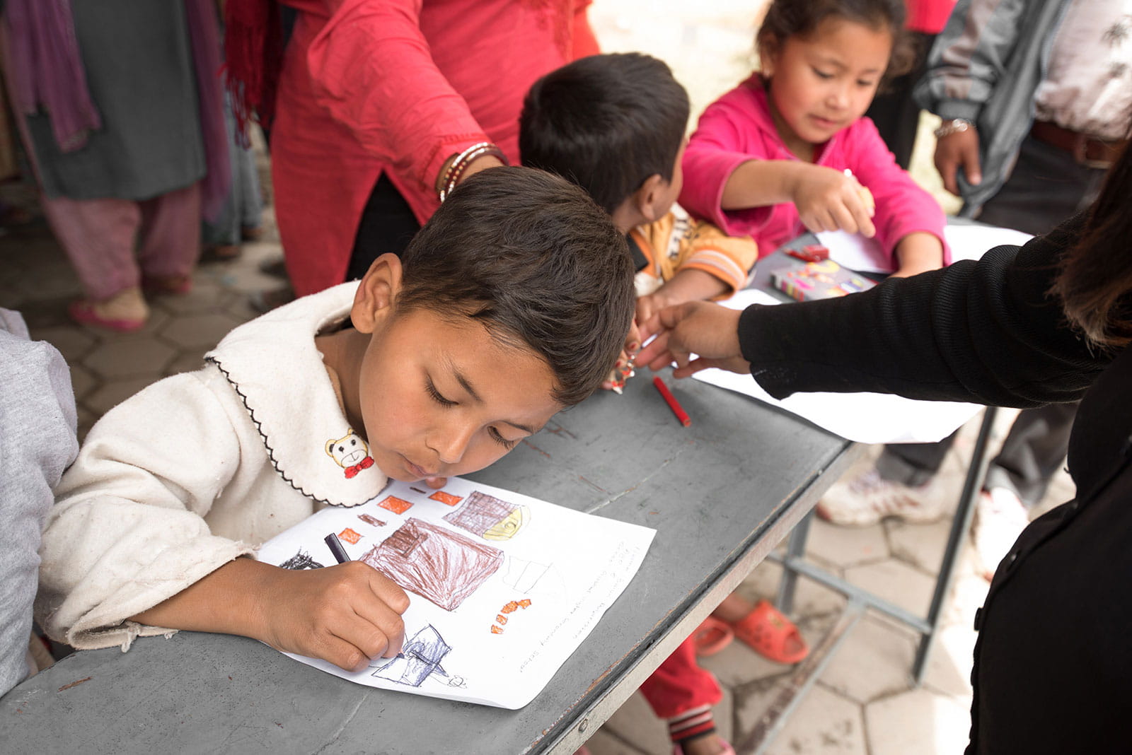 Picture of children drawing with color pencils