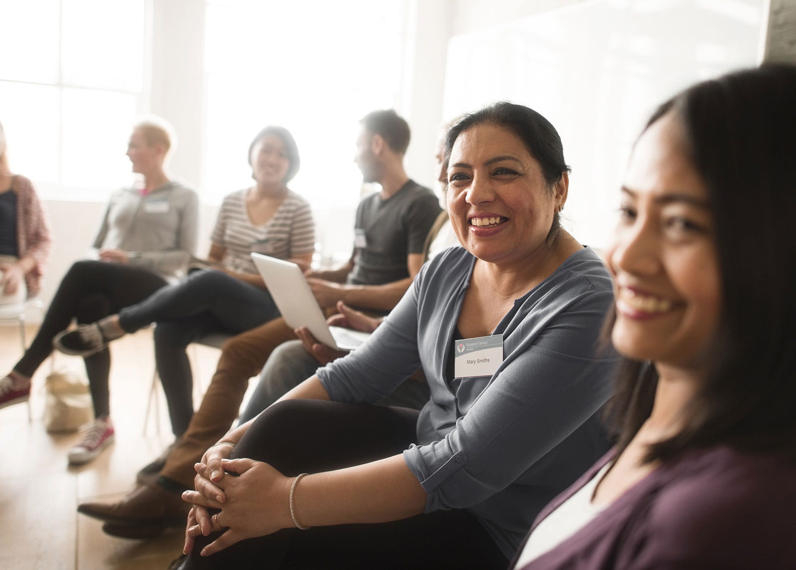 Patient support group meeting members smiling