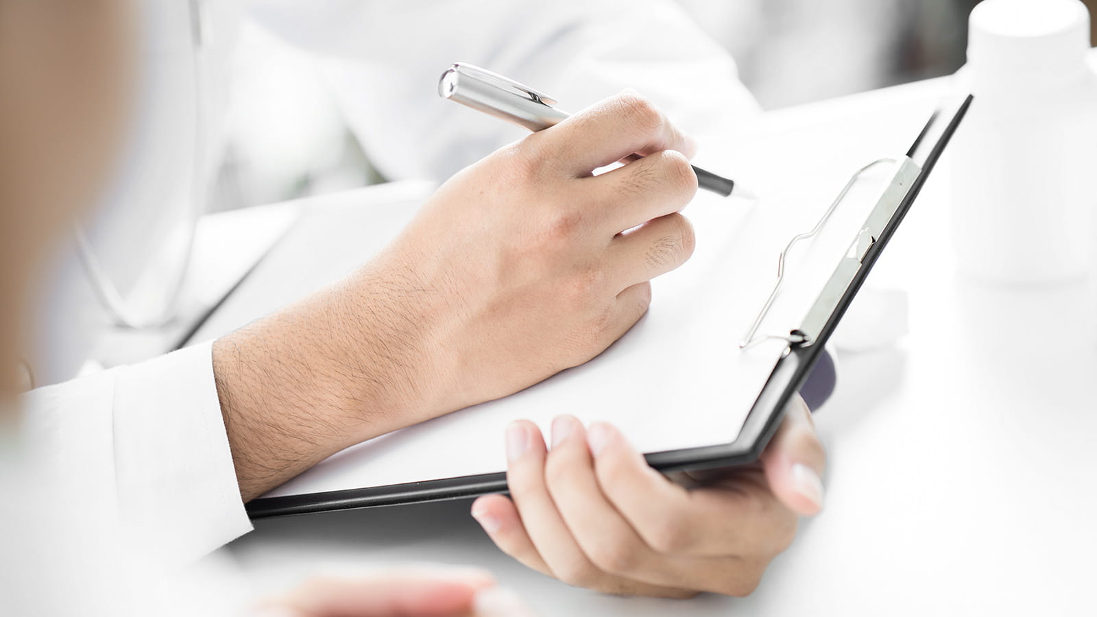 Person taking note on a clipboard