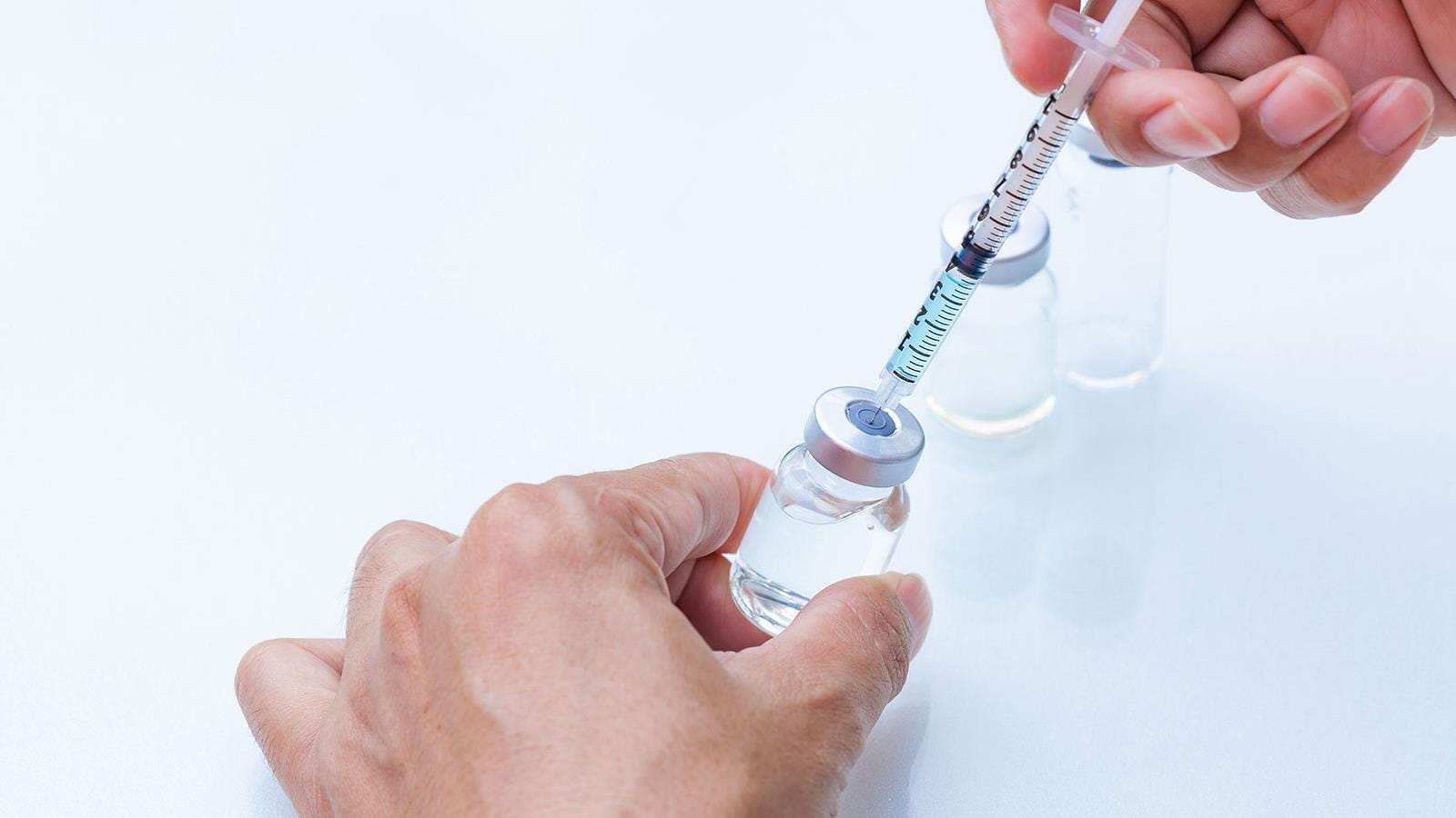 Syringe drawing fluid