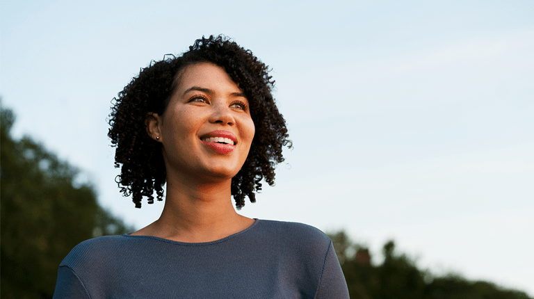Picture of a woman standing outside and smiling