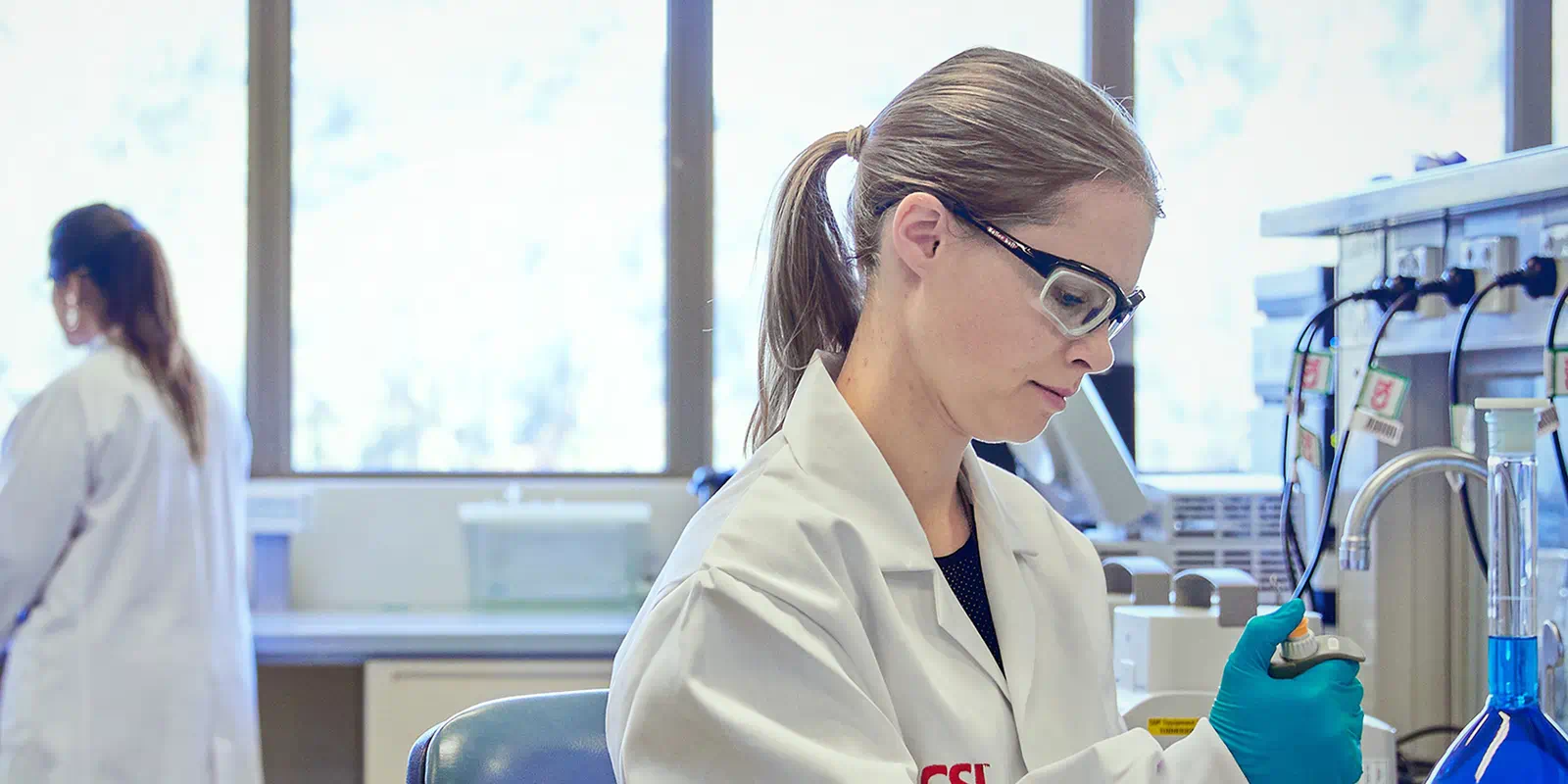 Woman looking at test tubes in a laboratory