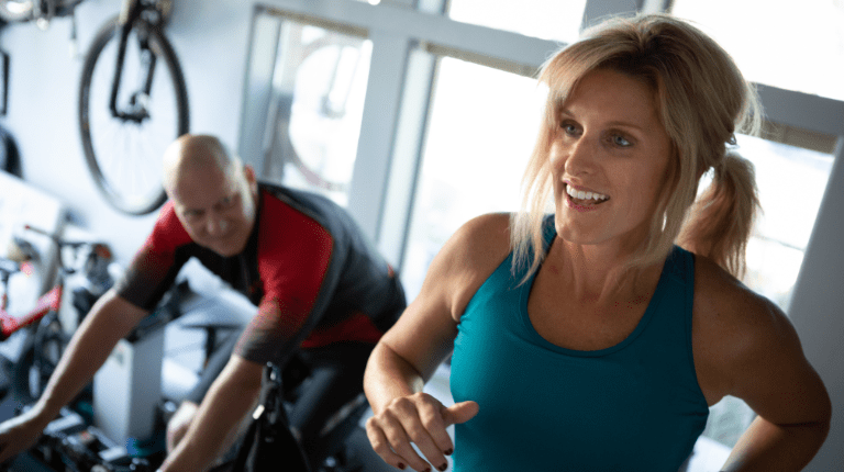 Picture of a woman and man exercising on gym equipment
