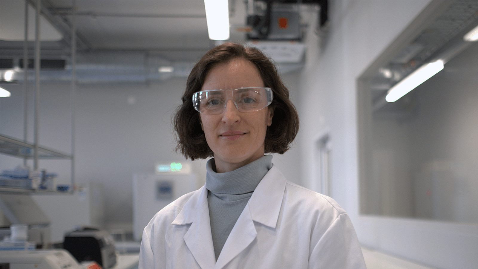 Picture of a female scientist wearing PPE in a laboratory environment