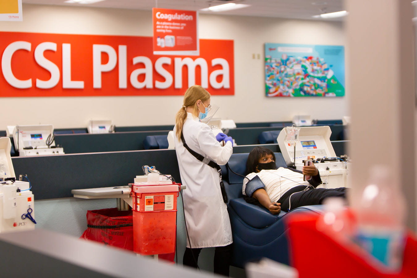 A plasma donor looks at her phone while donating at a CSL Plasma center. 