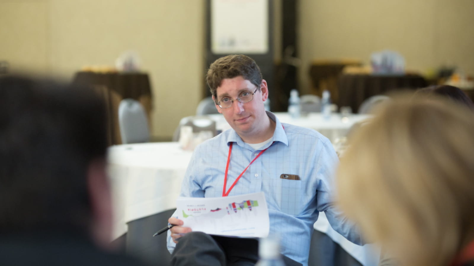 Seqirus Vice President Ethan Settembre seated in discussion with two others
