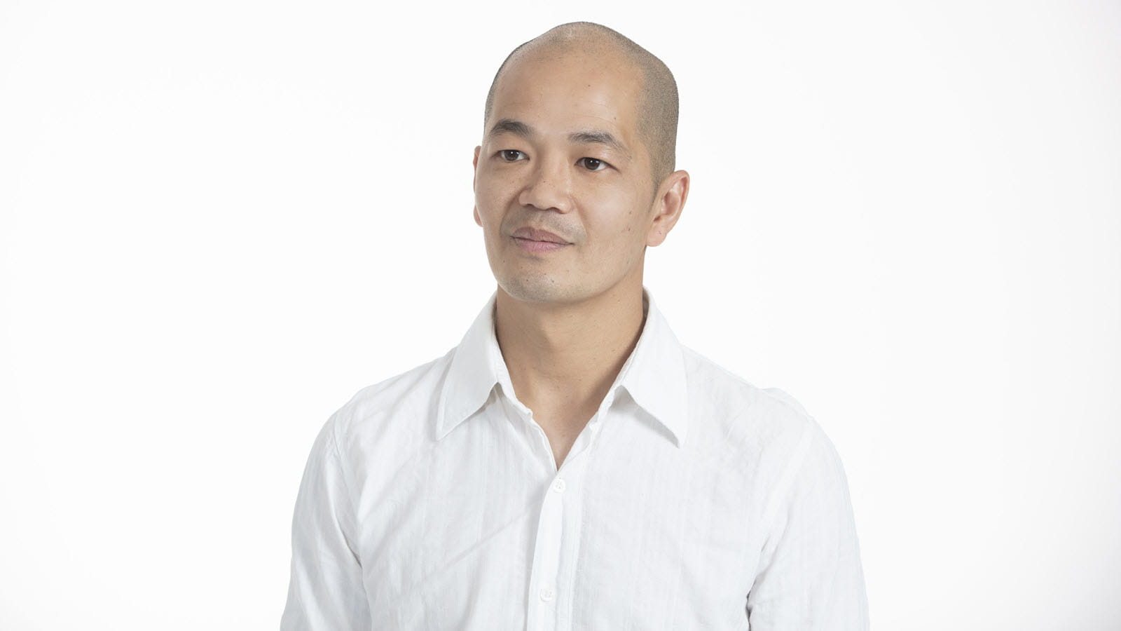Scientist Dave Leong in a white shirt on a white background