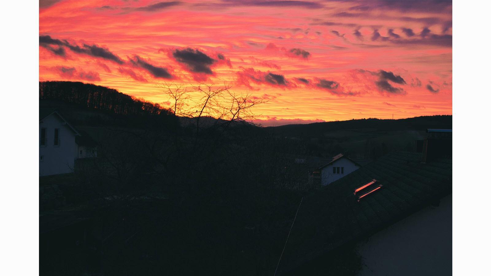 Orange and pink sunset over a mountain in Marburg, Germany