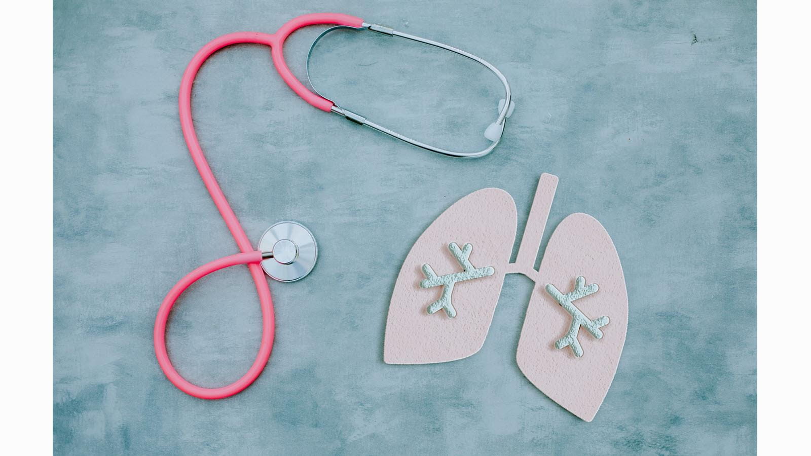 pink stethoscope and cut out model of lungs