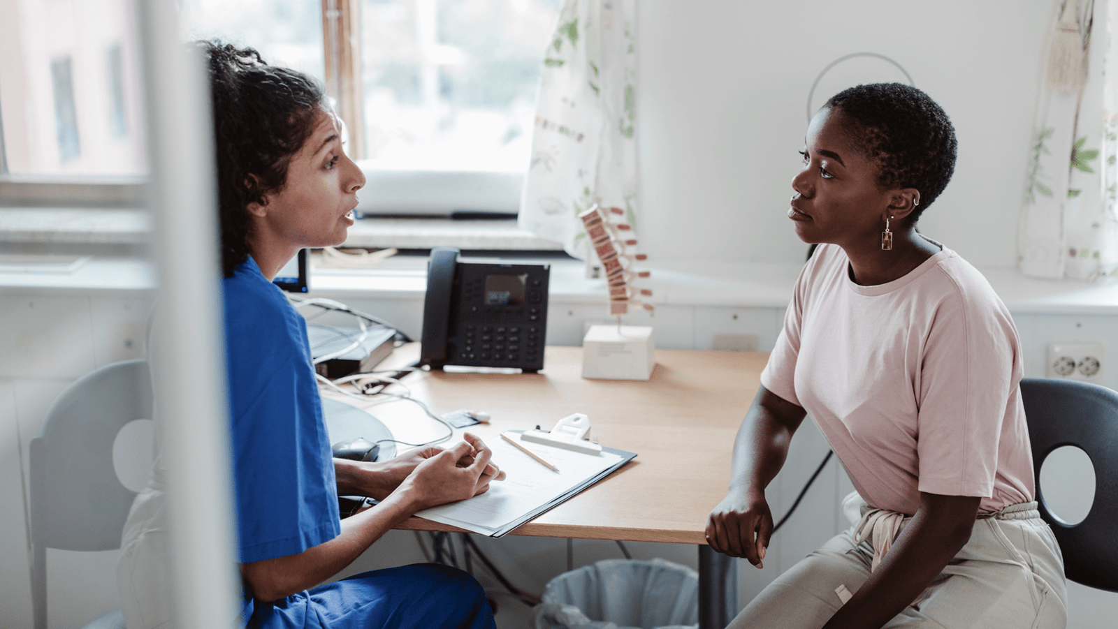 A nurse counsels a patient