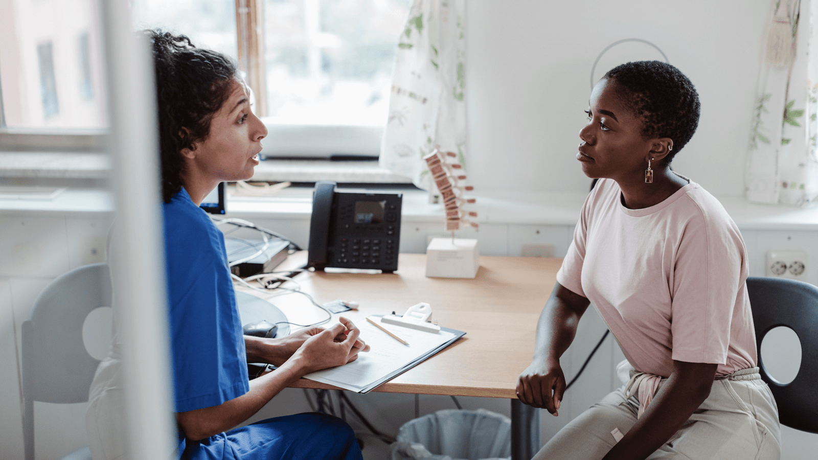 A nurse counsels a patient