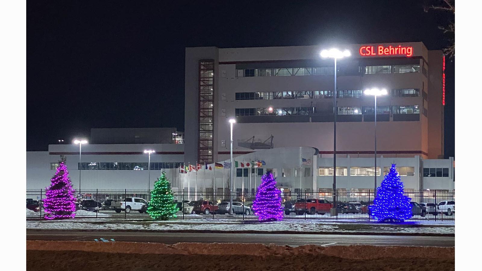 CSL Behring's manufacturing plant in Kankakee, Illinois lit up trees on the property in the pink, green, purple and blue colors of Rare Disease Day.