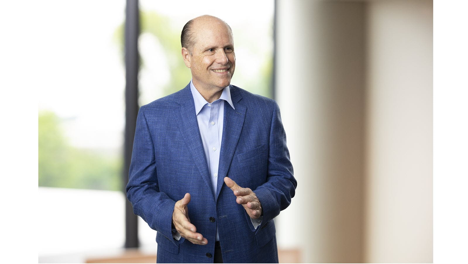CSL Limited CEO Paul Perreault in front of a window in a blue jacket