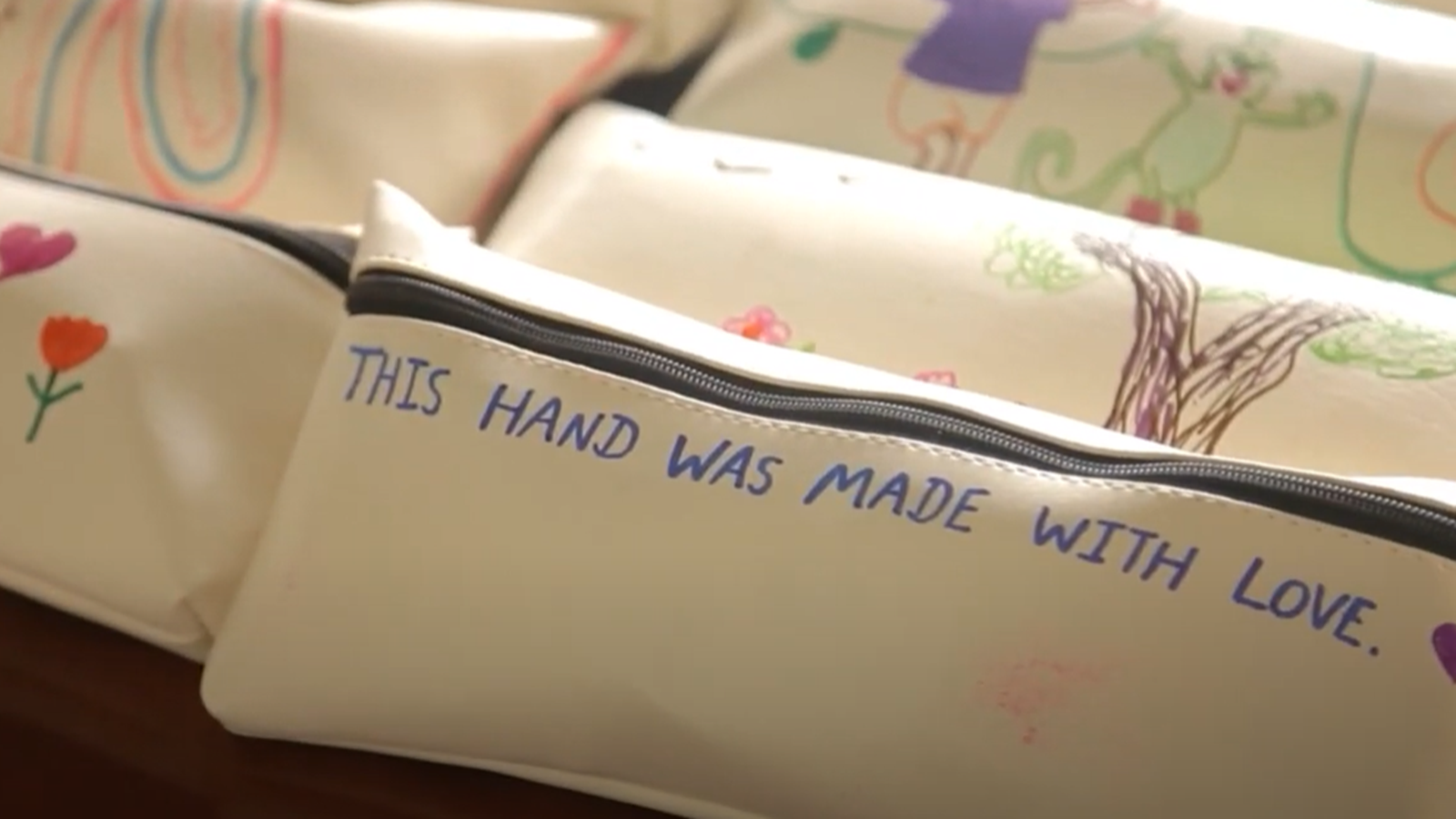 Zippered pouch that says "This hand was made with love."