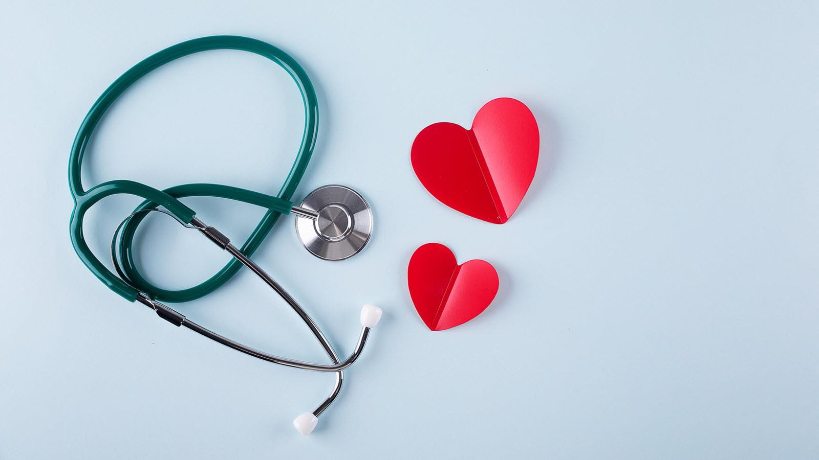 stethoscope alongside red, cut-out paper hearts