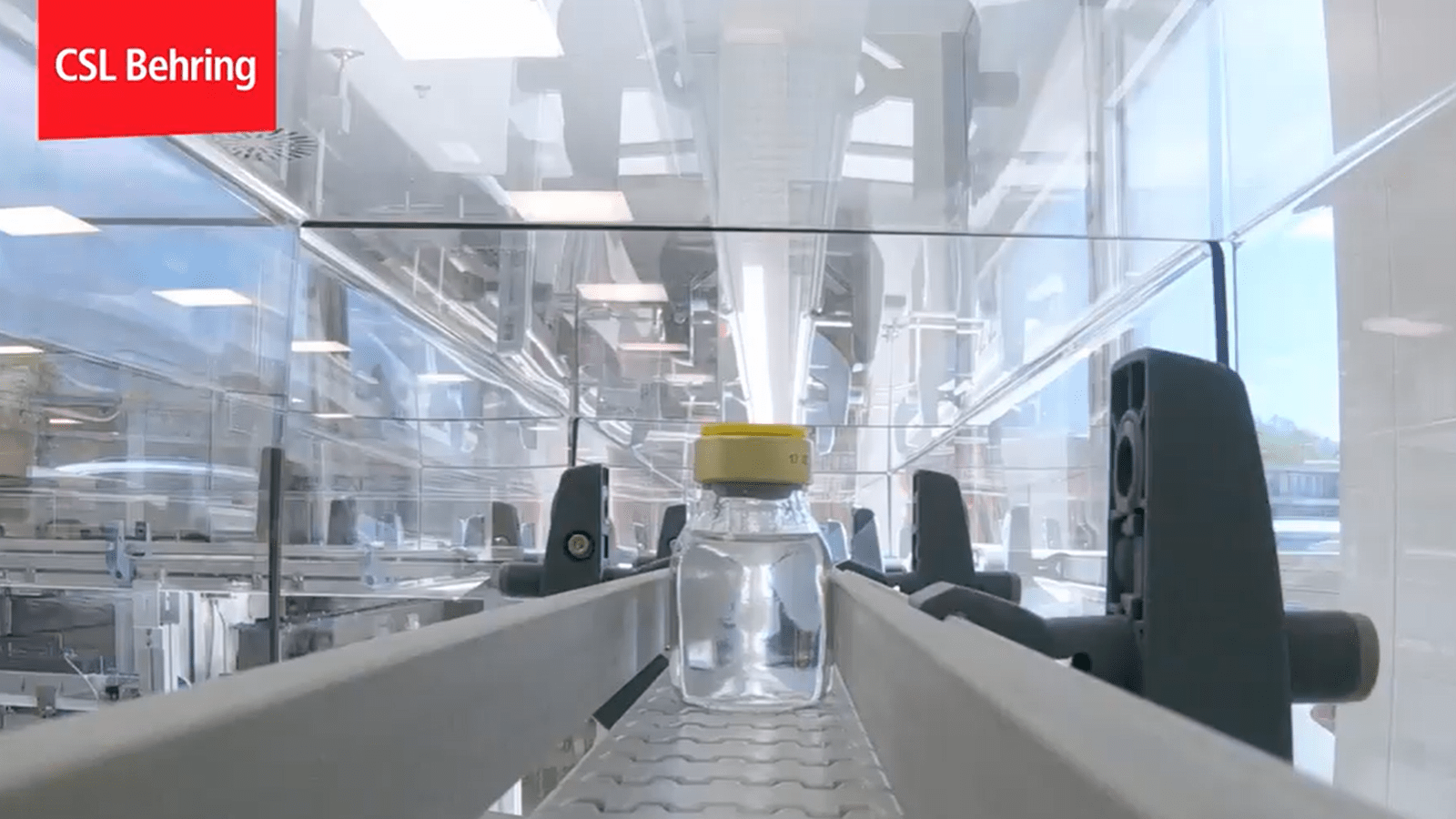 a single vial of medicine sits on a packaging conveyor