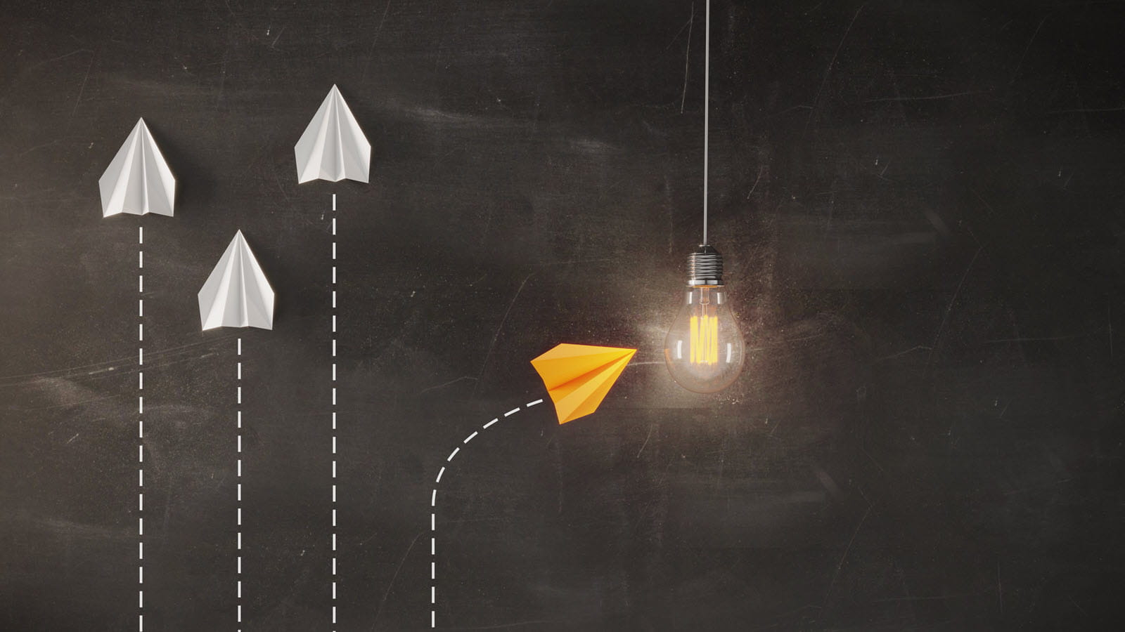 Four paper airplanes with one of them turning to the left toward a lightbulb