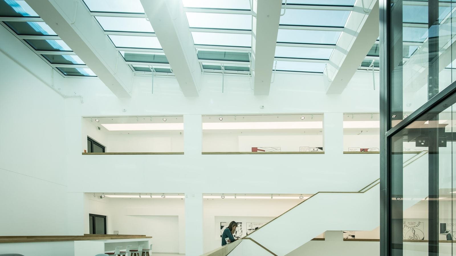 Someone goes up the exposed staircase in the M600 R&D building's atrium.