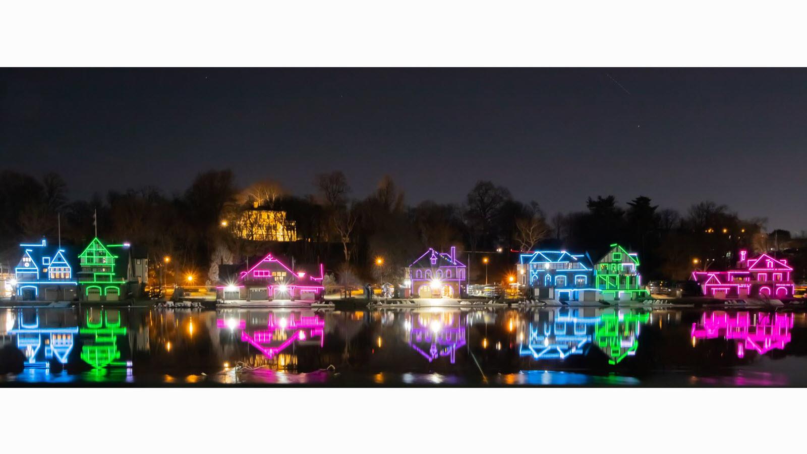 Philadelphia's Boathouse Row illuminated in the blue, green, pink and purple colors of Rare Disease Day