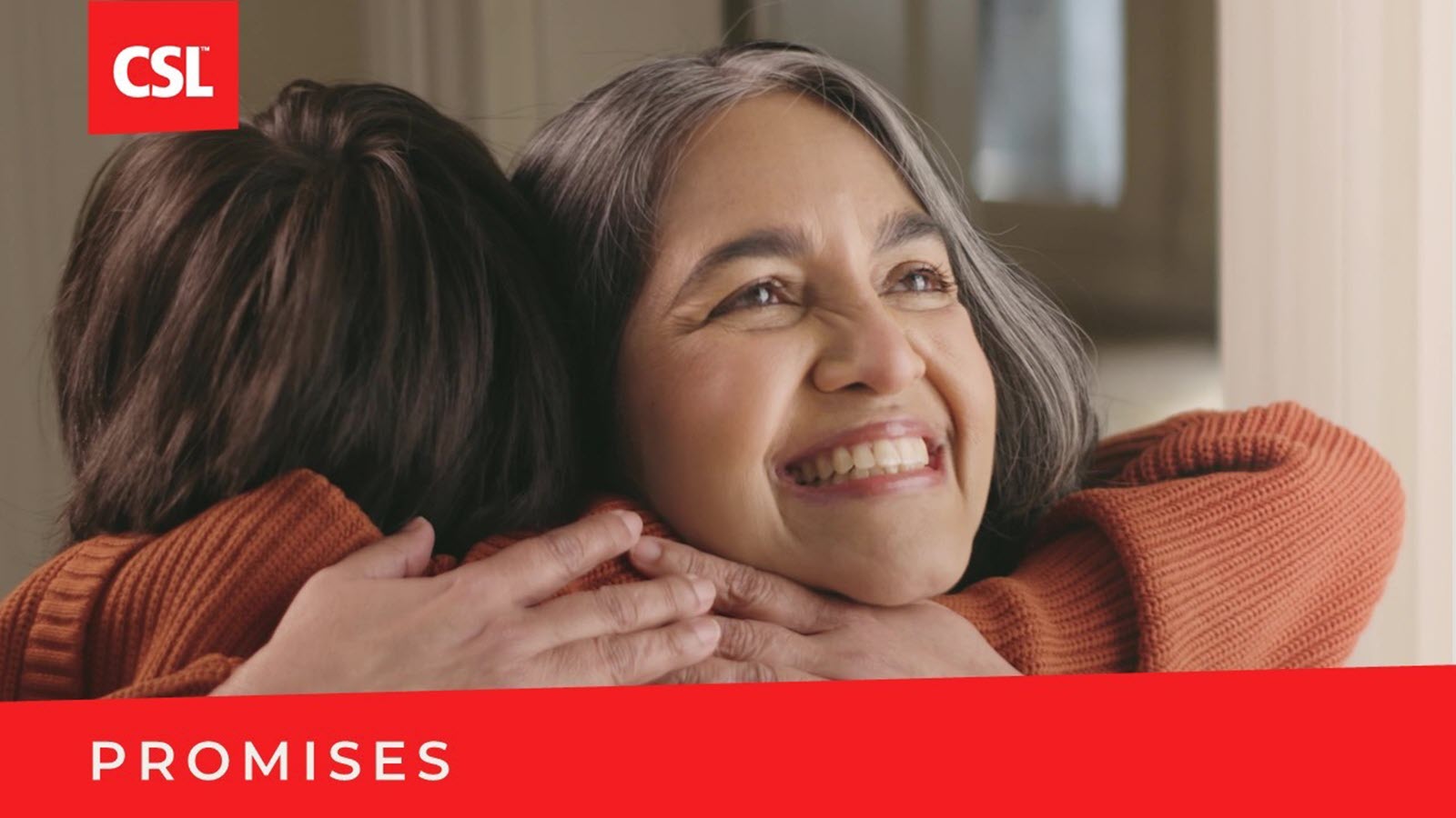 A woman in an embrace. This is a still photo from PROMISES, CSL's brand anthem. 
