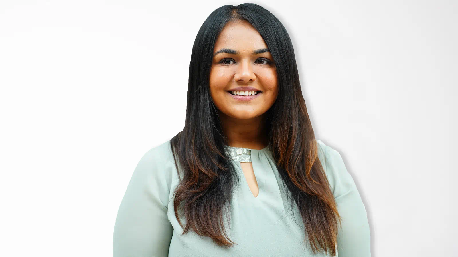CSL Scientist Shailee Patel in a mint green shirt on a white background