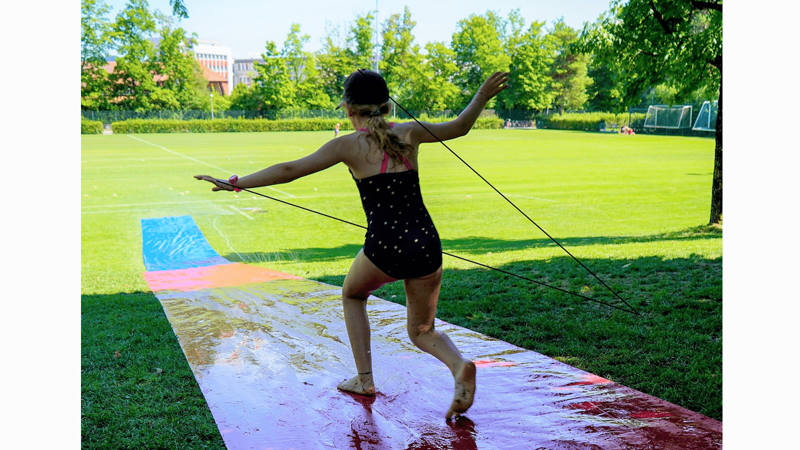 A child prepares to slide on a water slide.