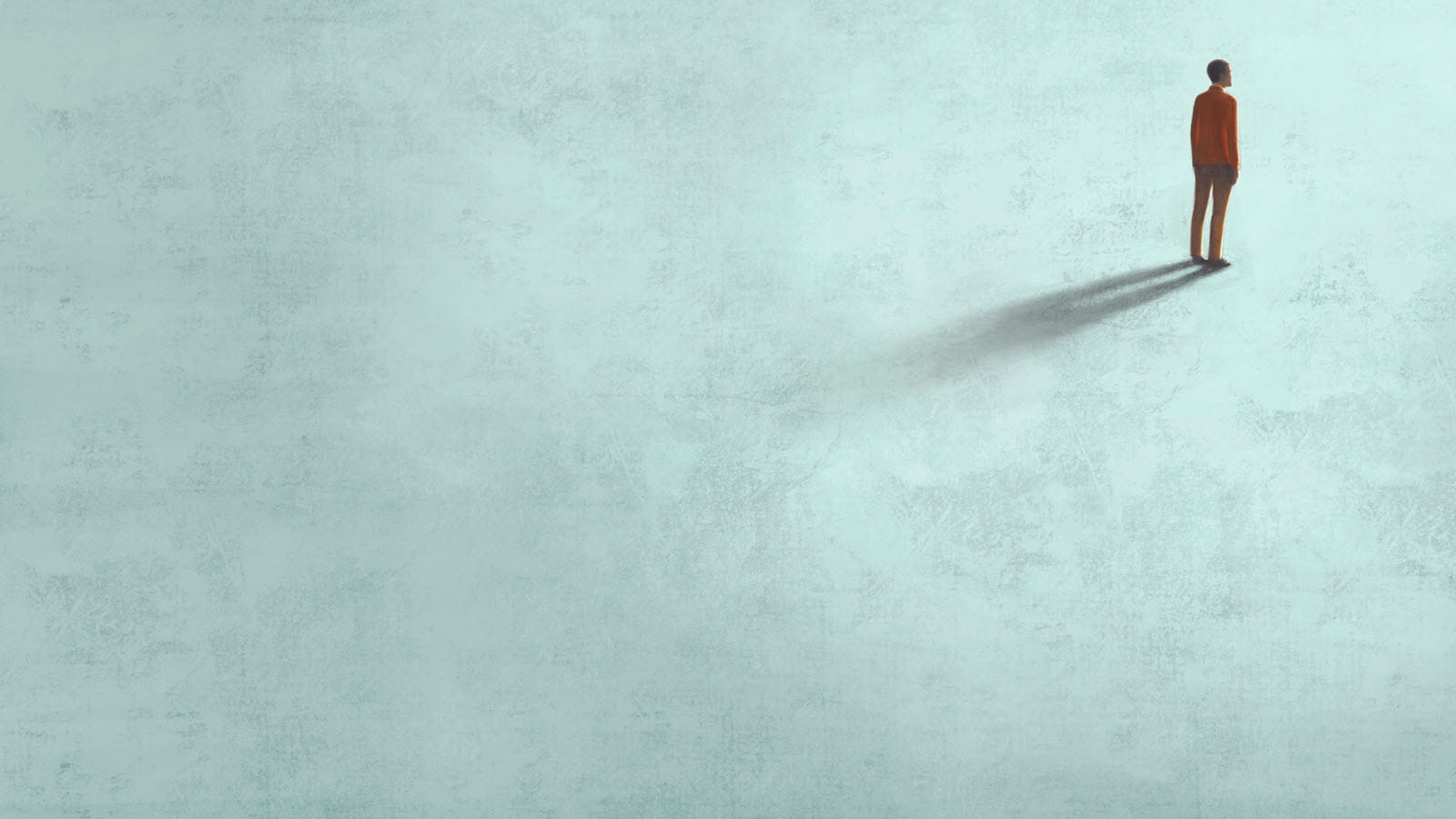 Person standing alone in the upper right corner of an empty space