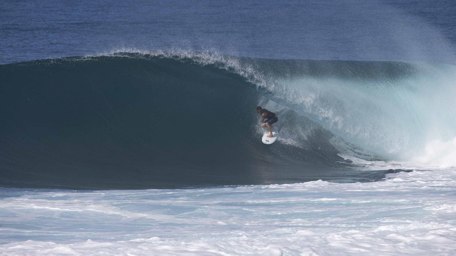 Surfer Arran Strong in the curl of a wave in Hawaii