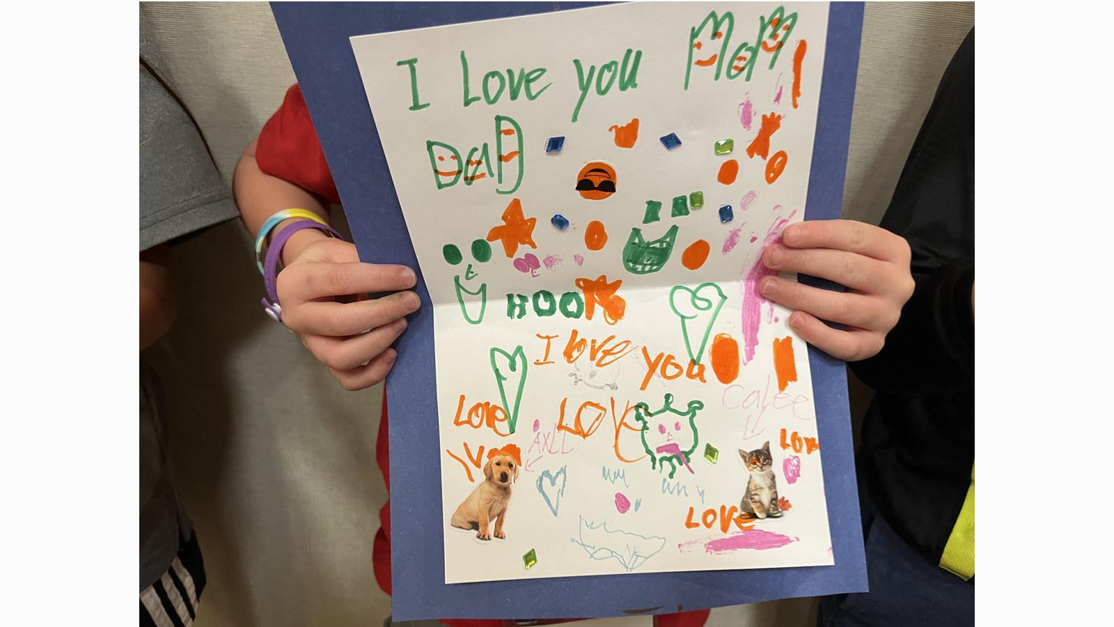Hand drawn card by a child in marker. "I love you Mom and Dad."