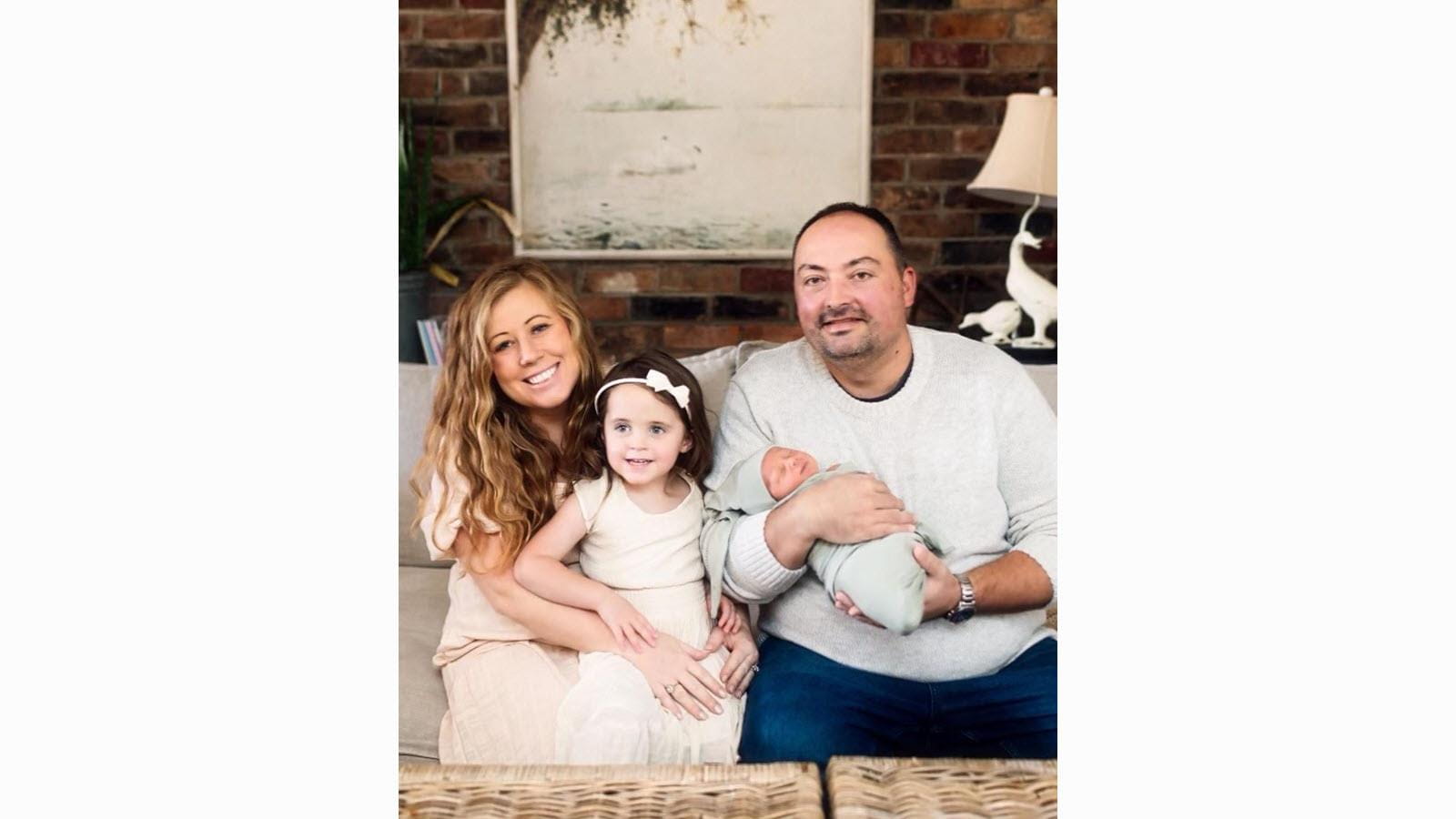 A portrait of the Williamson family, including their new baby and young daughter