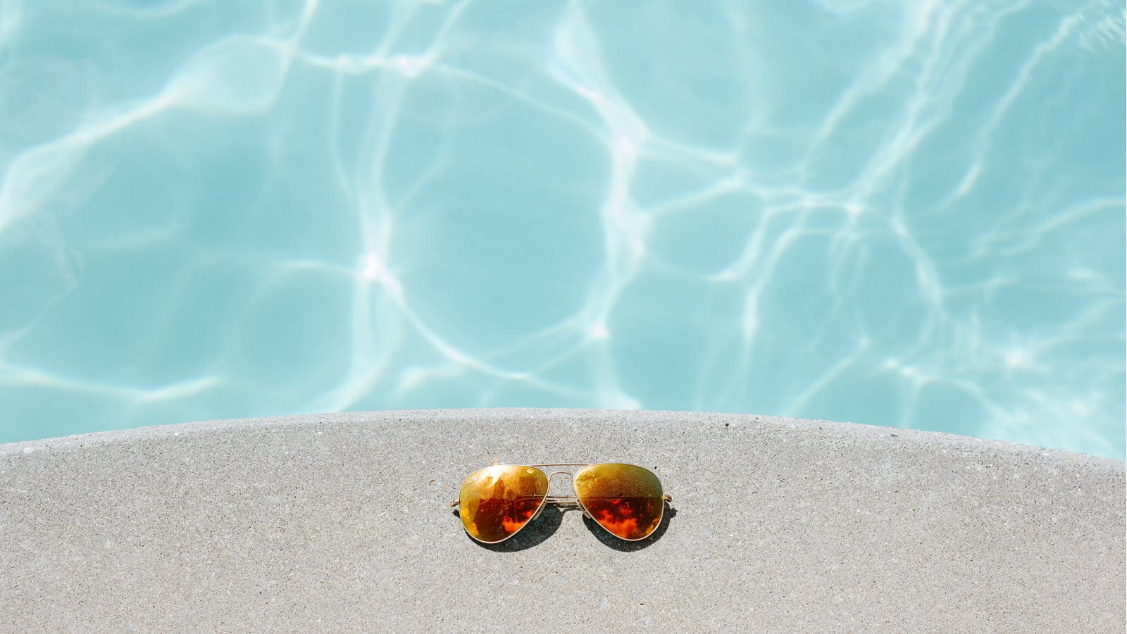 Mirrored sunglasses at poolside
