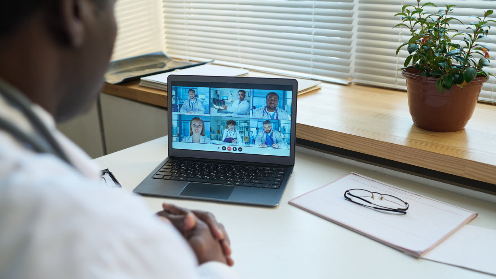 Doctor speaks on a webinar call.