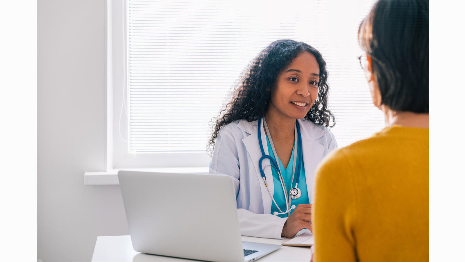 A doctor listening to a patient
