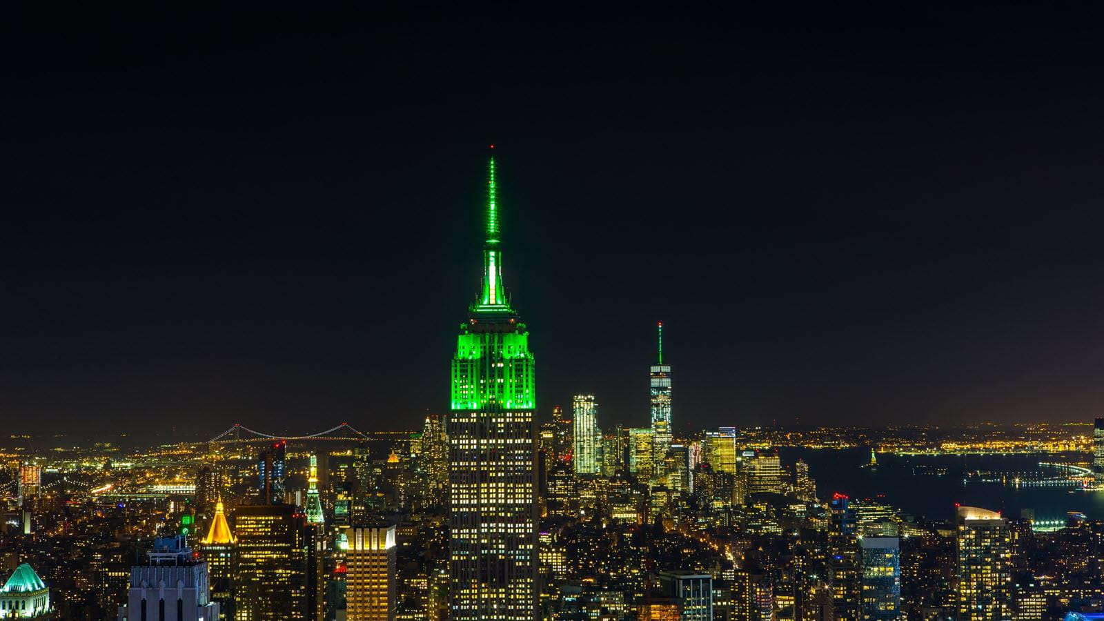 New York's Empire State Building at night lit up in green